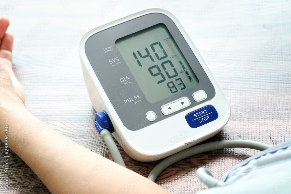 Man check blood pressure monitor and heart rate monitor with digital pressure gauge. Health care and Medical concept Man check blood pressure monitor and heart rate monitor with digital pressure gauge. Health care and Medical concept