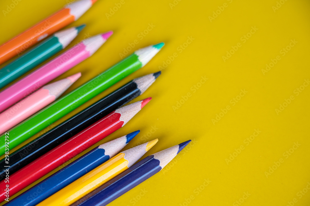 Fototapeta premium Colorful drawing pencils on yellow background