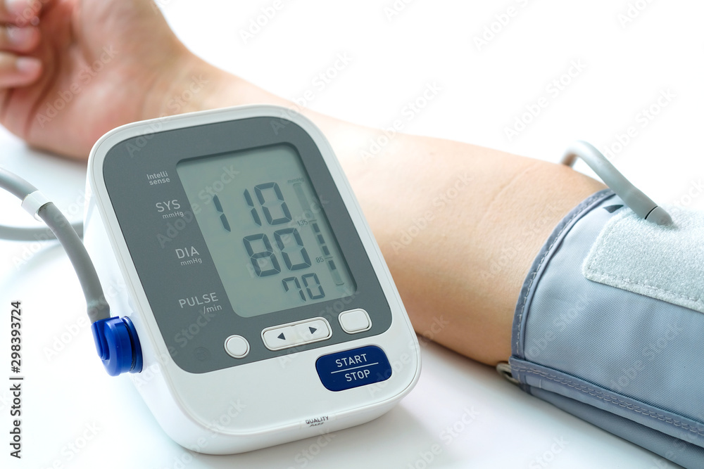 Man check blood pressure monitor and heart rate monitor with digital pressure gauge. Health care and Medical concept Man check blood pressure monitor and heart rate monitor with digital pressure gauge. Health care and Medical concept