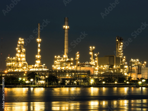 Oil and gas refinery plant area near the river at twilight, sunset time