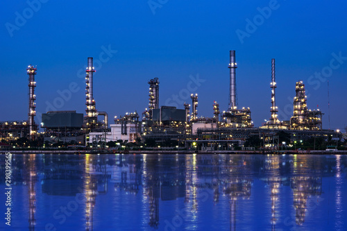 Oil and gas refinery plant area near the river at twilight, sunset time