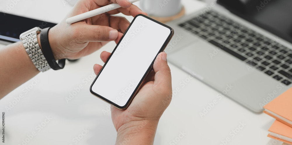 Close-up view of businessman surfing the internet on blank screen smartphone Close-up view of businessman surfing the internet on blank screen smartphone