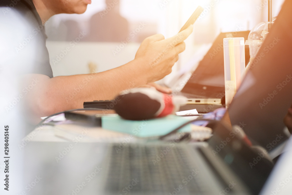 Close up hands of businessman working using smartphone and laptop on table workspace with sunlight. business working background concept. Close up hands of businessman working using smartphone and laptop on table workspace with sunlight. business working background concept.