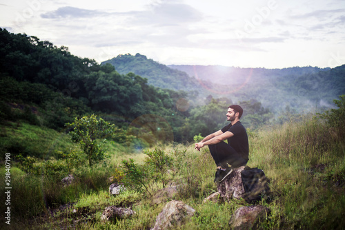 Traveller man with backpack sitting on rock at outdoor,Meditations to calm your mind and body © gballgiggs