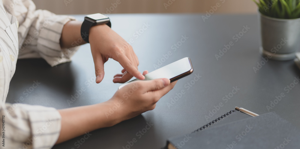 Close-up view of young professional businesswoman touching blank screen smartphone Close-up view of young professional businesswoman touching blank screen smartphone
