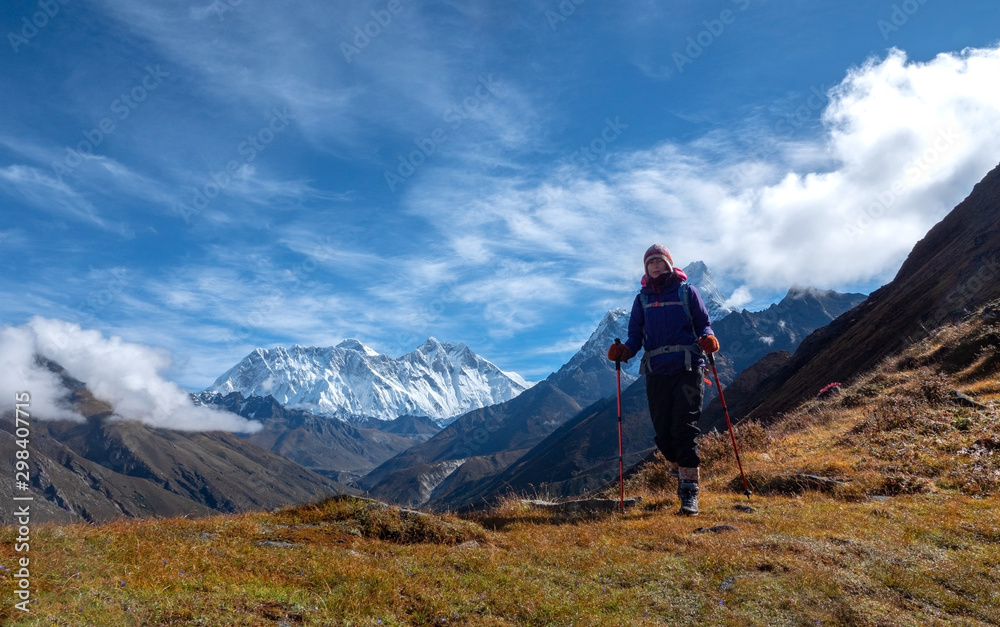 Fototapeta premium Active hiker hiking, enjoying the view at Himalaya mountains and Mount Everest landscape. Travel sport lifestyle concept