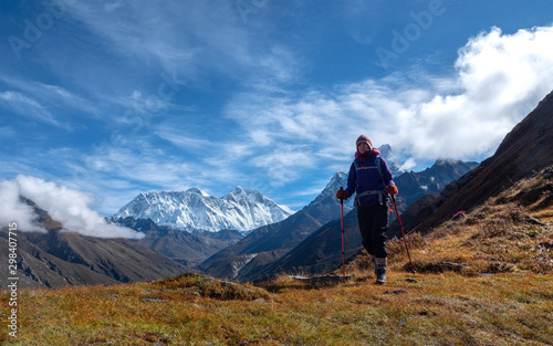 Active hiker hiking, enjoying the view at Himalaya mountains and Mount Everest landscape. Travel sport lifestyle concept