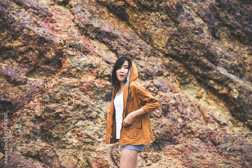 Portrait of hipster young girl standing near cliff and looking something at outdoor,Happy and smiling