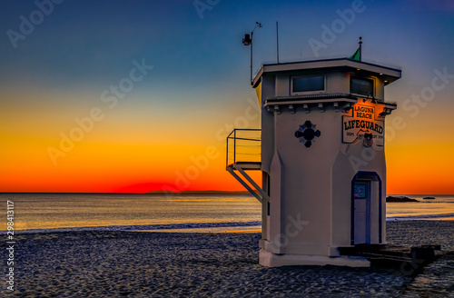 Sunset in Laguna Beach, famous tourist destination in California, USA with a lifeguard station in the foreground