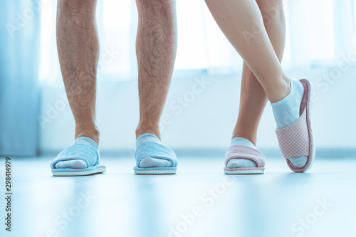 Loving family couple in home cozy soft comfortable slippers. Family concept