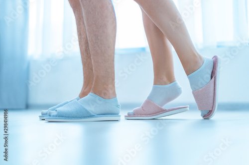 Loving family couple in home cozy soft comfortable slippers. Family concept