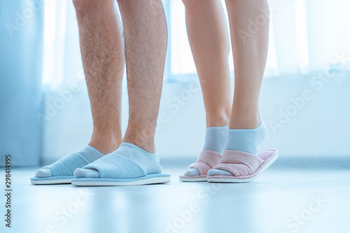 Loving family couple in home cozy soft comfortable slippers. Family concept © Goffkein