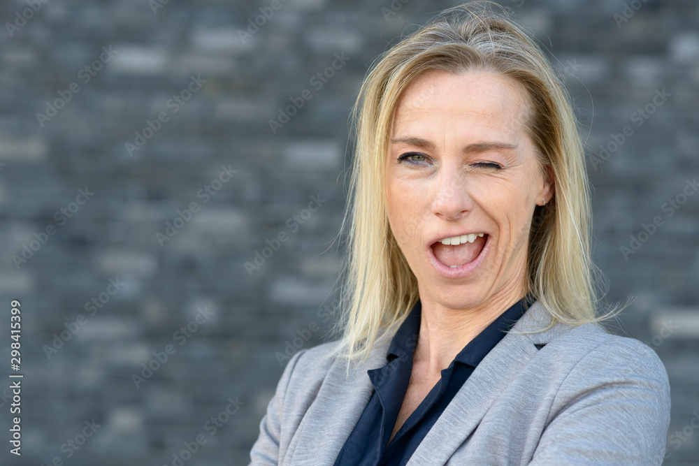 Blond woman winking in funny way Blond woman winking in funny way