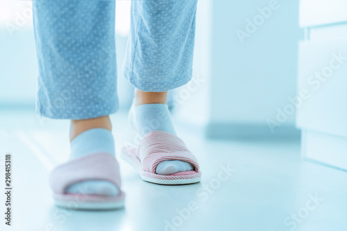 Woman in pajamas and female home cozy soft comfortable slippers