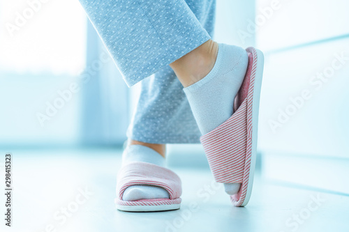 Woman in pajamas and female home cozy soft comfortable slippers