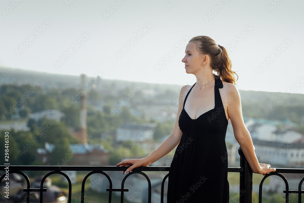 Portrait of a beautiful girl on a background of a big city