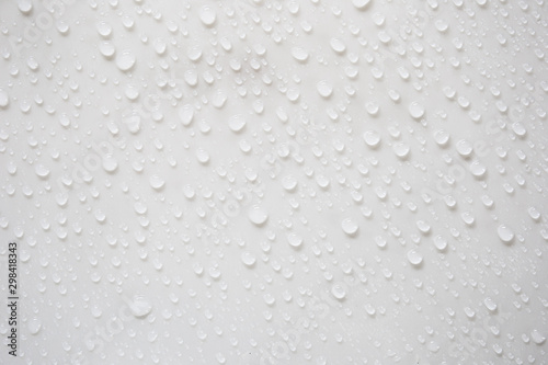 Raindrops on a grayish white background. Rainy season concept.