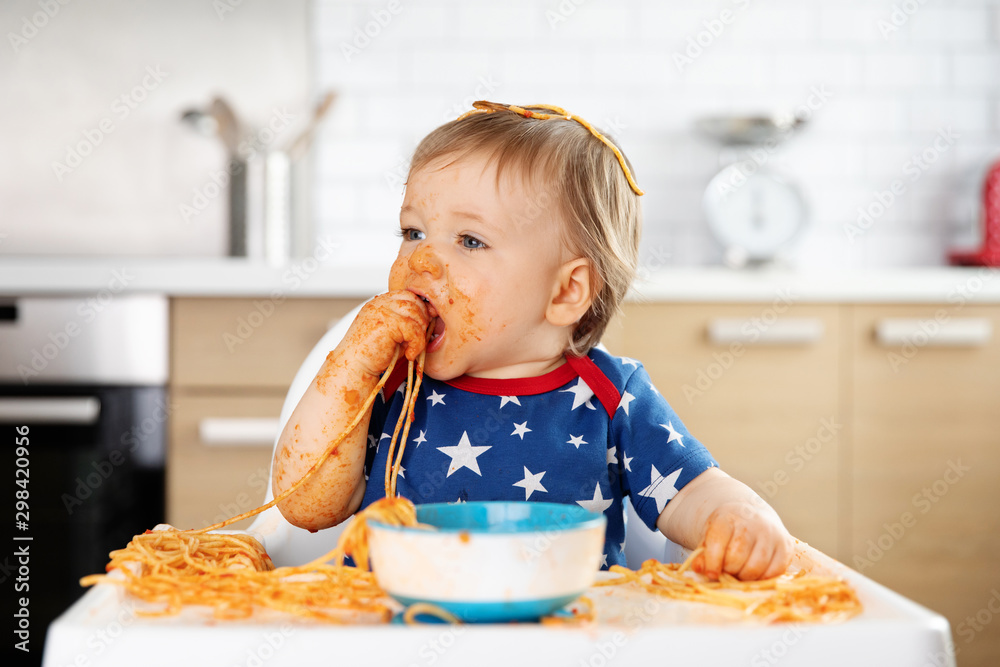 Messy baby eating spaghetti with his hands Messy baby eating spaghetti with his hands