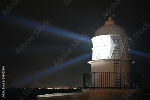 lighthouse at hakata in mid night photo