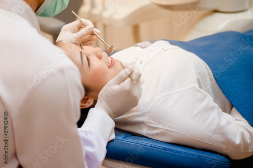 Dentist examining  teeth patients in clinic for better dental health and a bright smile. photo