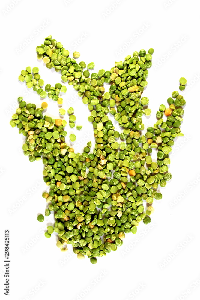 Dry green peas on a white background. Pea texture. Chipped dry peas for soup. Dry green peas on a white background. Pea texture. Chipped dry peas for soup.