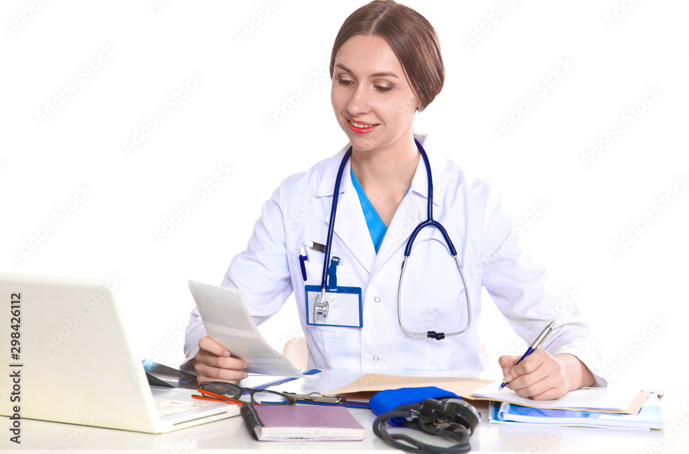 Portrait of young female doctor sitting at desk in hospital Portrait of young female doctor sitting at desk in hospital