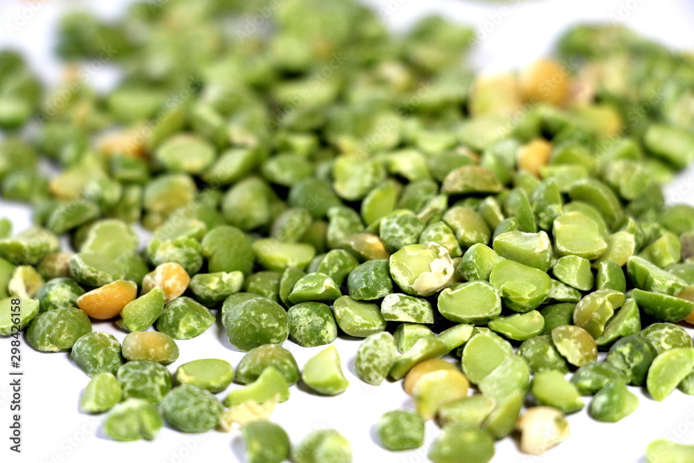 Dry green peas on a white background. Pea texture. Chipped dry peas for soup. Dry green peas on a white background. Pea texture. Chipped dry peas for soup.