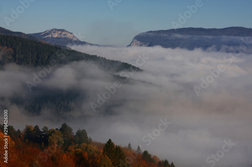 Fog collapsing into valley in autumn.