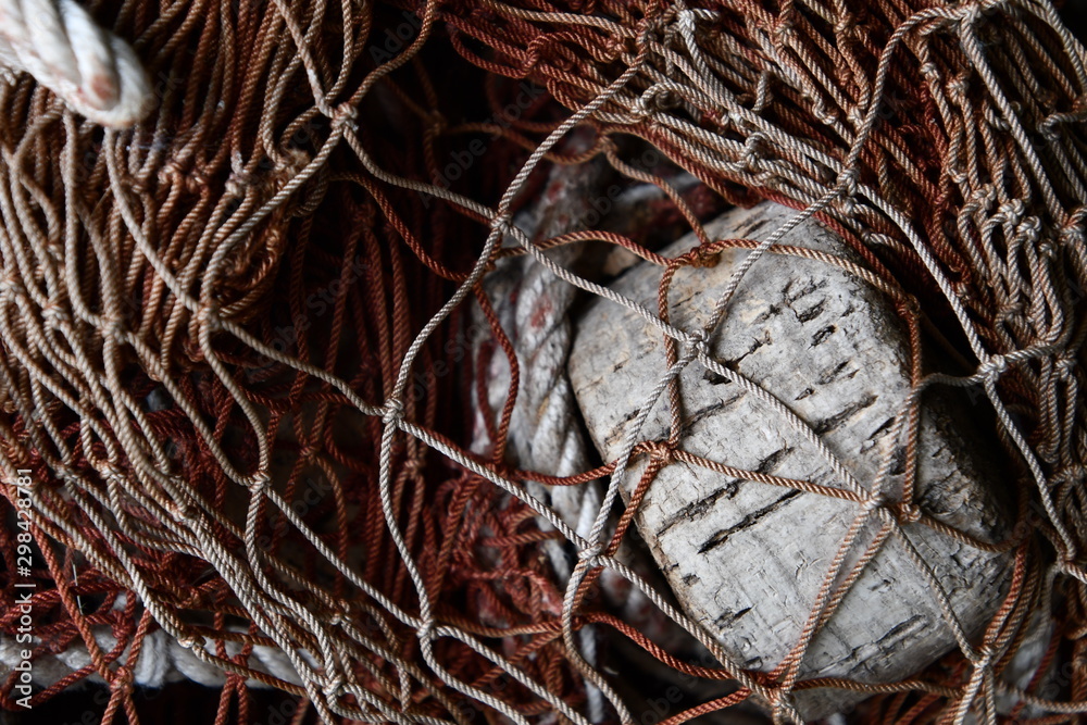 Fishing net and float in a pile in closeup
