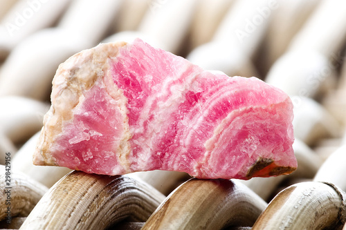 Macro photography of a rhodocrosite stone on a wicker background