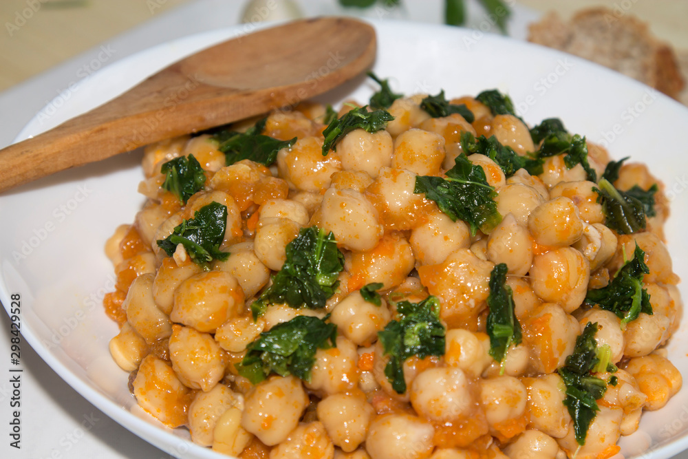 bowl of cooked chickpeas with spinach closeup view bowl of cooked chickpeas with spinach closeup view