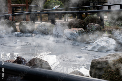 Oniishi bozu jigoku (Mud Hell), hot boiling grey bubbles mud pond in Umi Jigoku at Beppu, Oita-shi, Kyushu, Japan photo