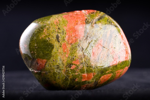 Macro photography of an unakite stone on a black background photo