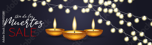 Dia de los Muertos (in Spanish) - Day of the Dead. Traditional Mexican holiday event. Banner or website header. Dark blue background with burning candles, golden lettering, and glowing lights garland.
