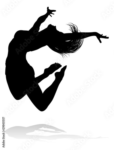 A silhouette woman dancing in mid air jumping