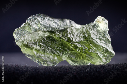 Macro photography of a moldavite stone on a black background