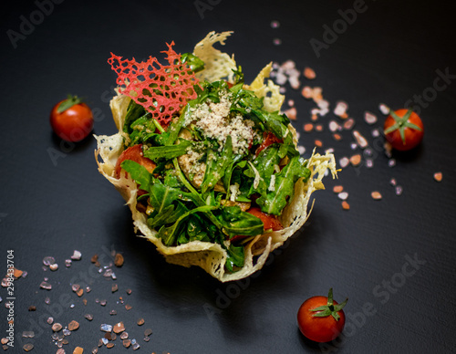 salad with cheese basket on a black background