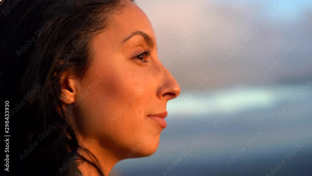 An attractive, young woman looks happy, confident and content as she looks at the landscape - profile close up 4K An attractive, young woman looks happy, confident and content as she looks at the landscape - profile close up 4K