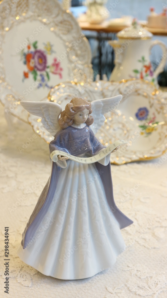 antique dish with angel figurine