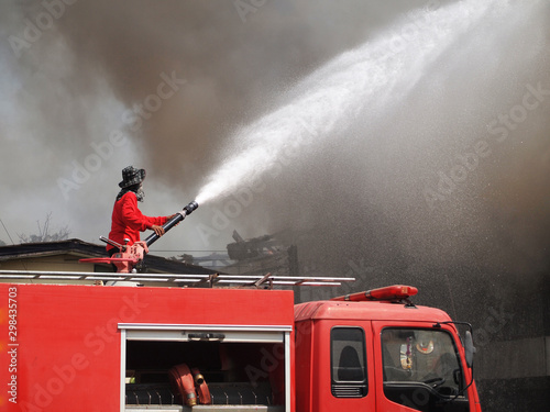 Fireman are spraying water to put out fire.
