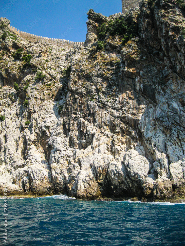 The rocky coast of the Black Sea off the coast of Turkey on a sunny summer day. The rocky coast of the Black Sea off the coast of Turkey on a sunny summer day.