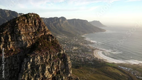 Fly-By Cinematic Aerial Shot of Cape Town's Lions Head Peak Revealing Camps Bay and Table Mountain National Park During Golden Hour Sunset