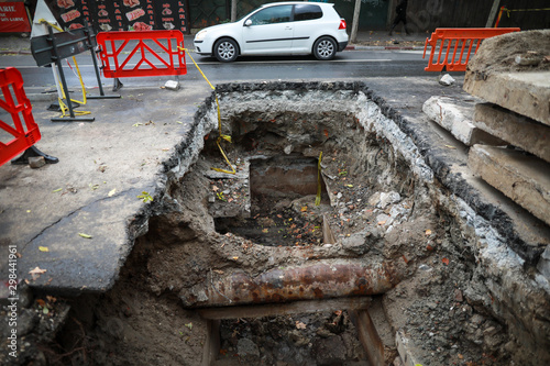 Huge hole in the ground made by the city hall workers to change hot water pipes from the Bucharest's thermal energy distributor RADET.