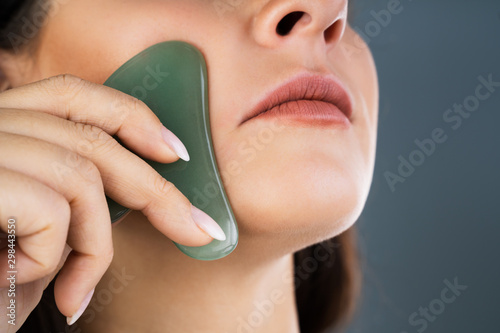 Young Woman Doing Gua Sha photo