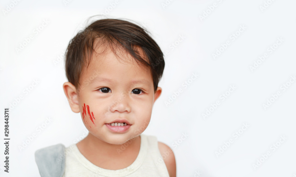 Portrait of little Asian baby boy with face make up sticker lesion on face in Halloween costume looking out over white background. Portrait of little Asian baby boy with face make up sticker lesion on face in Halloween costume looking out over white background.