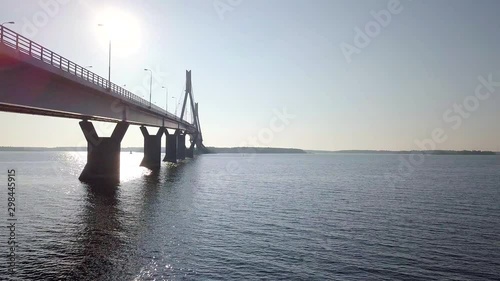 Aerial tracking shot, morning sun lighting up beautiful landscape around the cable-stayed Replot bridge, in Vaasa, Finland photo