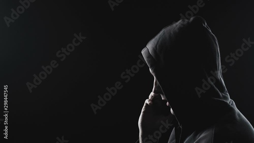 Video of man talking on phone in the hood