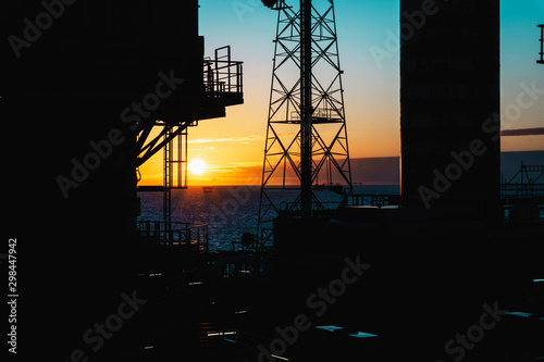 Offshore Morning Sunrise though communication tower and crane.