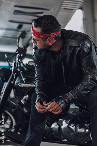 Caucasian biker looking at somebody in garage