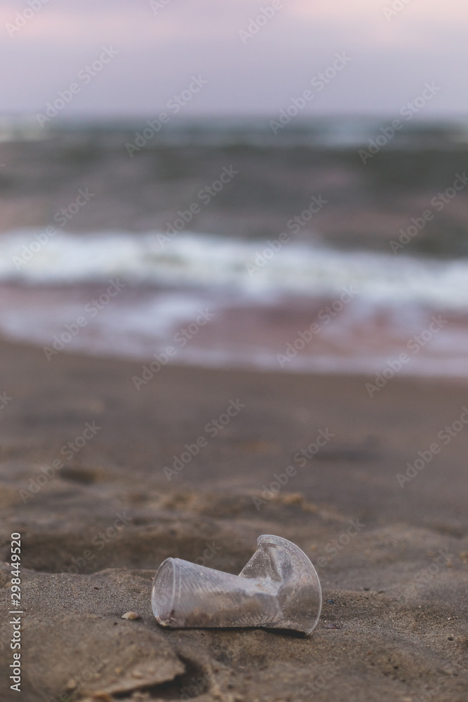 A small plastic cup on the seashore. A small plastic cup on the seashore.